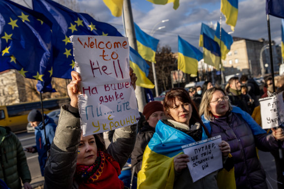 People hold signs and chant slogans during a protest outside the Russian Embassy in Kyiv, Ukraine, this week.