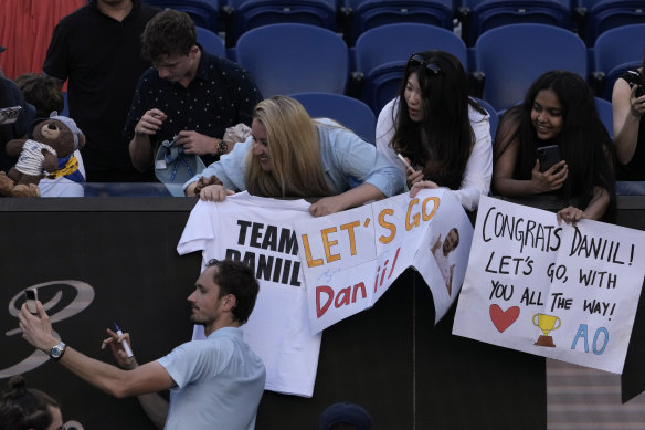 Medvedev takes a selfie with fans after defeating Samrej.