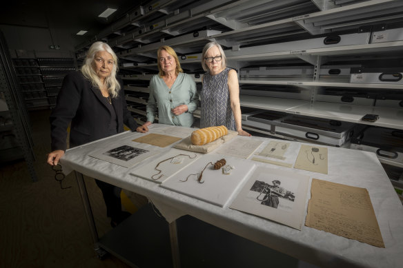 Professor Marcia Langton with Elaine Thomson and Professor Su Baker, with some of the artifacts.