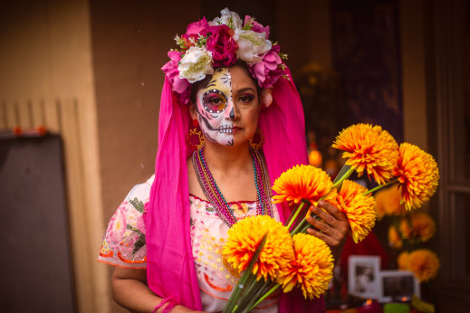 Susi Tovar with marigolds, a traditional Day of the Dead flower.