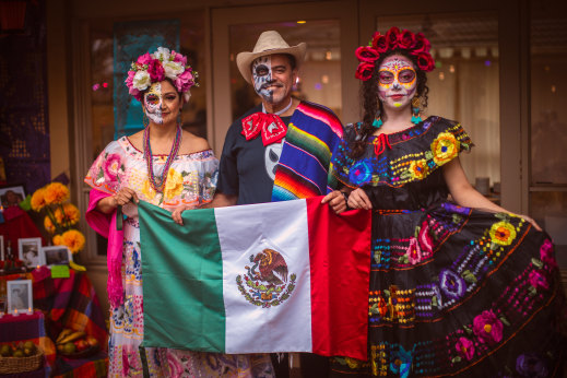 Expatriate friends (from left) Susi Tovar, Pedro Chan and Flor Labana with a Mexican flag.