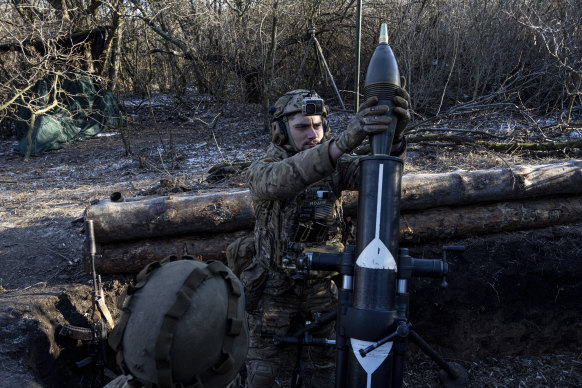 A Ukrainian serviceman prepares to fire a 120 mm mortar towards Russian positions at the frontline near Bakhmut, Donetsk region, Ukraine.