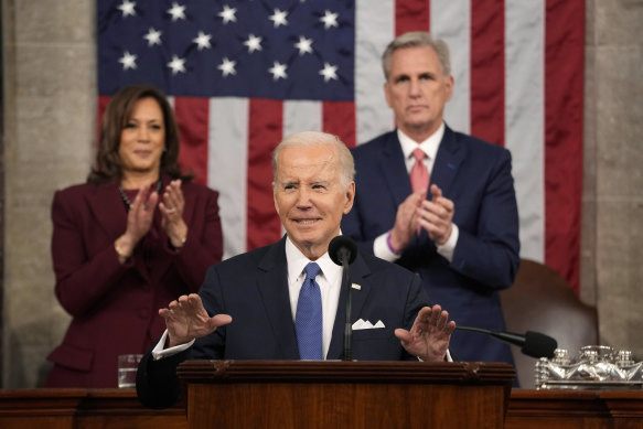 US President Joe Biden delivering his State of the Union address, flanked by Vice President Kamala Harris and House Speaker Kevin McCarthy.