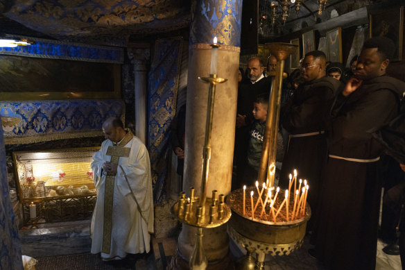 Christmas mass is held at the grotto with an infant doll depicting Jesus placed in it, believed to be the spot where he was born at Church of Nativity in Bethlehem, West Bank. 