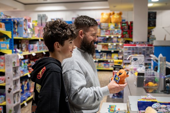Alexander Mazniovski, 11, buys a squishy from Toyworld with his dad Tony, who says the toys can be used as “calming” tools. 
