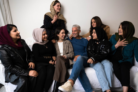 Craig Foster with his daughters and five young Afghan women who he helped escape from Kabul. From left: Madina, Hosna, Frishta, Foster’s daughter Jemma, Foster, his other daughter Charlie, Lida and Sahila.