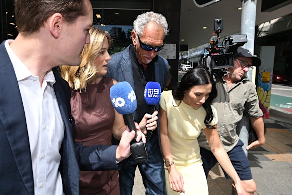 Andrew Wood (centre), the father of Sam Wood, is seen arriving at the Brisbane Supreme Court on Friday.