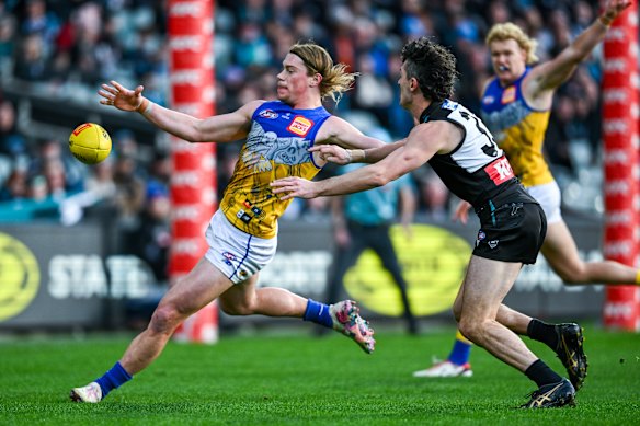 Harley Reid of the Eagles kicks past Darcy Byrne-Jones of the Power during the round 18 AFL match.