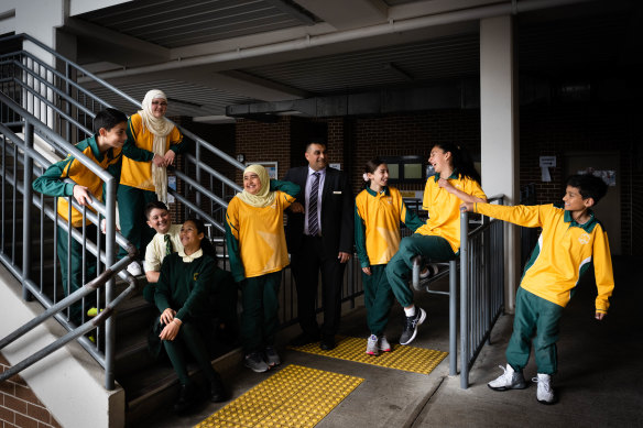 Principal Osman Karolia with students at Arkana College in Kingsgrove.