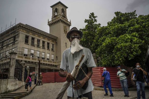 A pedestrian wearing a makeshift face mask amid the new coronavirus pandemic, walks past the Central Railway Station, in Havana, Cuba.