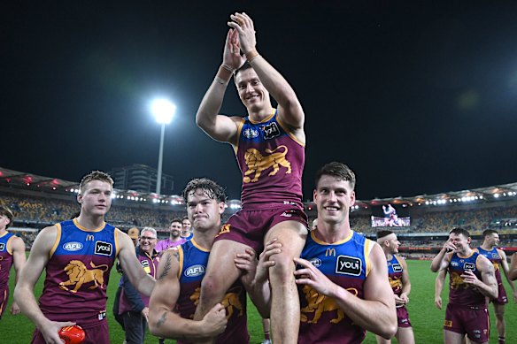 Hugh McCluggage of the Lions is chaired off to celebrate his 200th game.