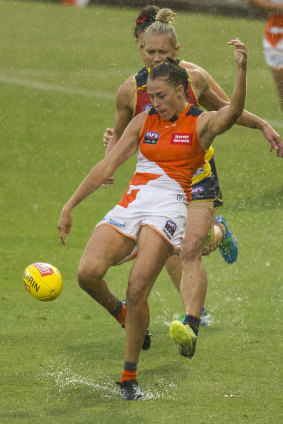 Splashing out: Aimee Schmidt of the Giants in action on a rain-soaked pitch at Sportspark in Sydney.