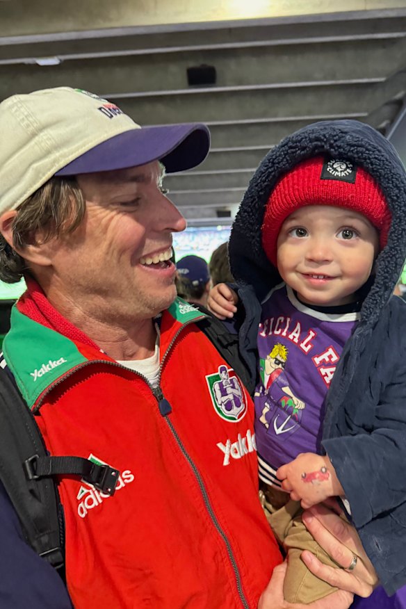 Chris Binns and his son Julian at the grand final, blissfully unaware of the heartbreaking turn to come. 