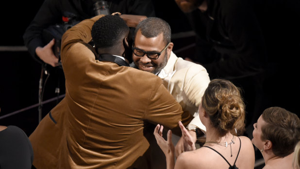 Daniel Kaluuya, left, congratulates Jordan Peele, winner of the award for best original screenplay for <i>Get Out</i> at the Oscars last weekend.