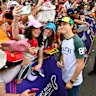 Oscar Piastri greets fans at Albert Park - it can be a rush to land a spot by the fence.