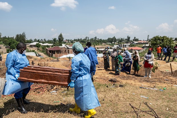 Red Cross workers prepare to bury Vanisa Anifa, a 6-month-old orphaned girl who died of Ebola, at the Bigo Cemetery, in Bunia, Congo.