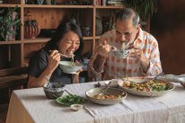 Helen Goh and Yotam Ottolenghi sharing dishes from the cookbook Comfort.