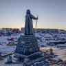 A statue commemorating Hans Egede, the Danish missionary who founded Nuuk in 1728, stands on a hill overlooking the town in Greenland.