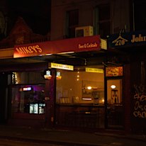Mikey’s is a new bar in Abbottsford featuring a martini stained-glass window (right).