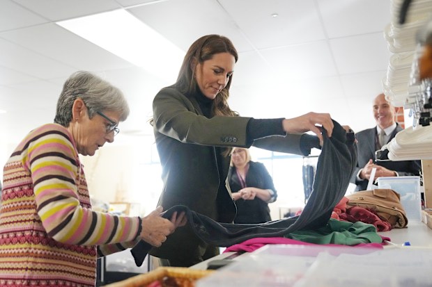  Catherine, Princess of Wales, is shown how to value donated clothes before they go on sale during a visit to East Anglia’s Children’s Hospices’ (EACH) shop on October 22, 2026 in Hoveton