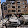 Israeli security forces inspect a destroyed building that were hit by a missile fired from Iran, in Holon, near Tel Aviv, Israel.