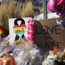 Bouquets of flowers sit on a corner near the site of a mass shooting at a gay bar in Colorado Springs, Colorado.