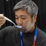 Kiyohiro Izumo uses the Kirin Electric Salt spoon which intensifies salt flavor by flowing a mild electric current through the food around the tongue to attract salt towards the tongue, during 2025 CES Unveiled, Sunday, Jan. 5, 2025, in Las Vegas. (AP Photo/Jack Dempsey)