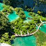 Serene walking trails through Plitvice Lakes National Park in Croatia.