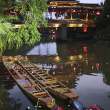 Two dragon boats that capsized sit in the water on the Taohua River in Guilin.