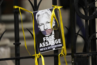 A poster of Julian Assange is attached to the gate at the entrance the High Court in London on Wednesday.