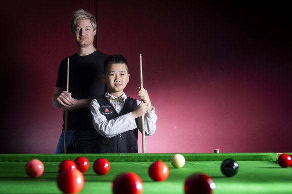 Neil Robertson with 11-year-old Austin Huang.
