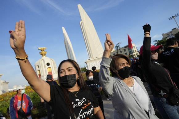 Anti-government protesters shout “Prayuth get out” as they gather in front of Democracy Monument to demand that Prime Minister Prayuth Chan-ocha step down from his position in Bangkok, Thailand on Tuesday.