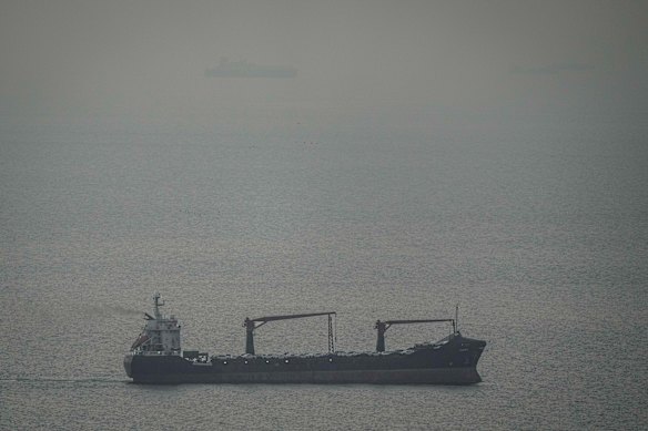 A cargo ship carrying vehicles sails through the Arabian Gulf toward the Strait of Hormuz in the UAE on Sunday.