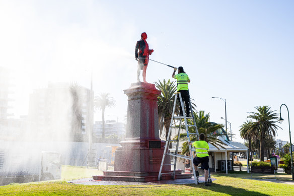 The red paint is cleaned off the Captain Cook statue in St Kilda.