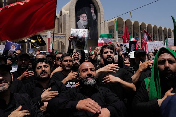 Mourners beat their chests as they attend the dayslong funeral ceremonies for the late Iranian Supreme Leader Ayatollah Ali Khamenei.