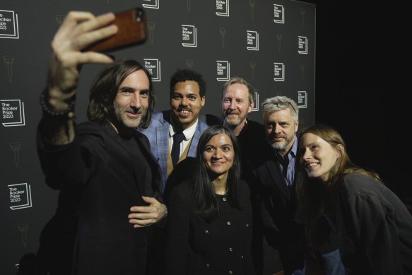 From left, authors Paul Lynch, Jonathan Escoffery, Chetna Maroo, Paul Murray, Paul Harding and Sarah Bernstein take a selfie during a photo call for the Booker Prize 2023 in London.