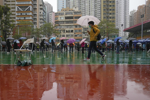 Residents line up to get tested for the coronavirus at a temporary testing centre despite the rain in Hong Kong on Tuesday.