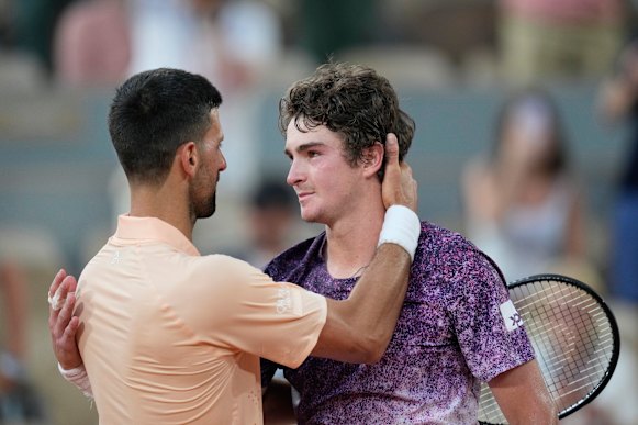 Novak Djokovic hugs Joao Fonseca after the youngster’s victory.
