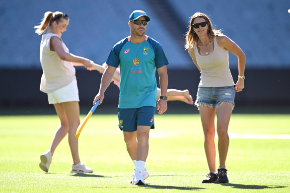 David Warner and wife Candice walk on the MCG pitch on Christmas Day.