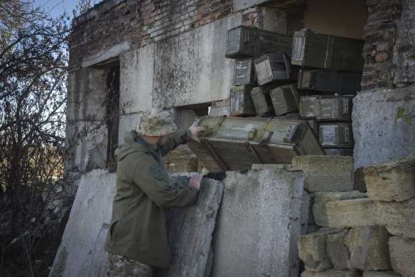 A sapper examines ammunition left by Russian troops in the village of Kiseliovka, close to Kherson, earlier this month.