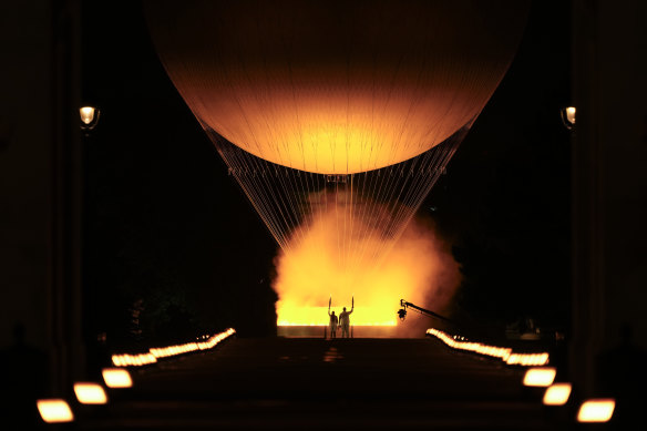 Teddy Riner and Marie-Jose Perec watch as the cauldron rises in a balloon in Paris, France, during the opening ceremony of the 2024 Summer Olympics.