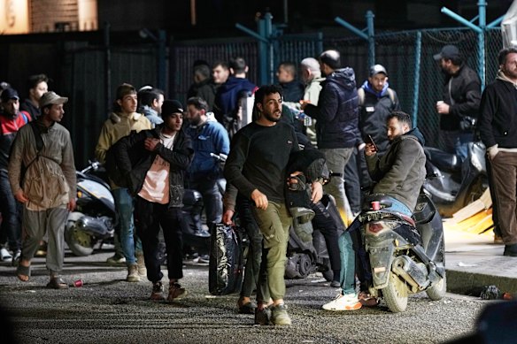 Residents flee their homes following Israeli airstrikes in Dahiyeh, a southern suburb of Beirut, Lebanon. 