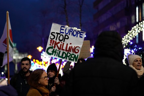 A protester holds a sign during a demonstration calling for a ceasefire in Gaza outside an EU summit in Brussels, on Thursday.