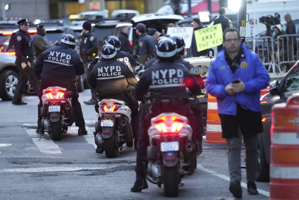 New York City police officers on scooters line up outside Manhattan criminal courts.