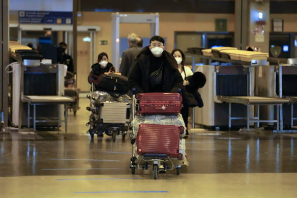 Passengers coming with an Air China flight from Guangzhou, China, leave a COVID-19 testing area set at Rome’s Leonardo da Vinci international airport in Fiumicino, on Thursday.