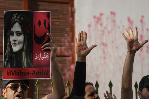 Iranian nationals protest against the death of Iranian Mahsa Amini, in front of the Chilean Human Rights Institute building in Santiago, Chile, on Friday.