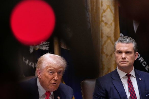 US President Donald Trump speaks at the White House on Tuesday as  War Secretary Pete Hegseth looks on.
