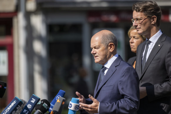 German Chancellor Olaf Scholz (left) speaks to the press near the scene of Friday’s knife attack.