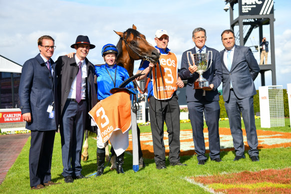 James McDonald poses with James Cummings and connections after riding Golden Mile to the win.