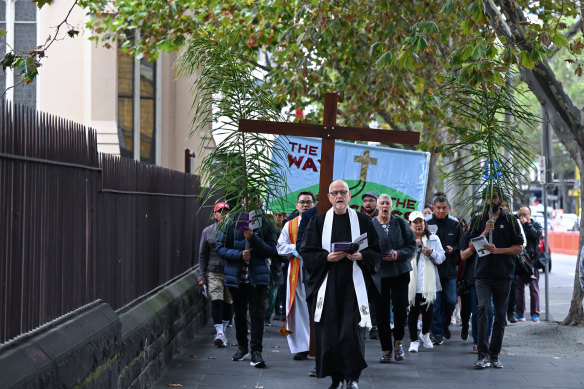 Reverend Dr Simon Holt, of the Collins Street Baptist Church, leads The Way of the Cross commemoration on Good Friday in Melbourne.
